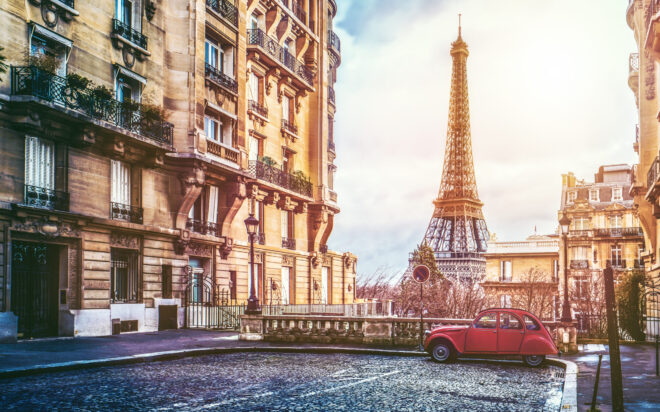 small paris street with view on the famous paris eifel tower on a cloudy rainy day with some sunshine